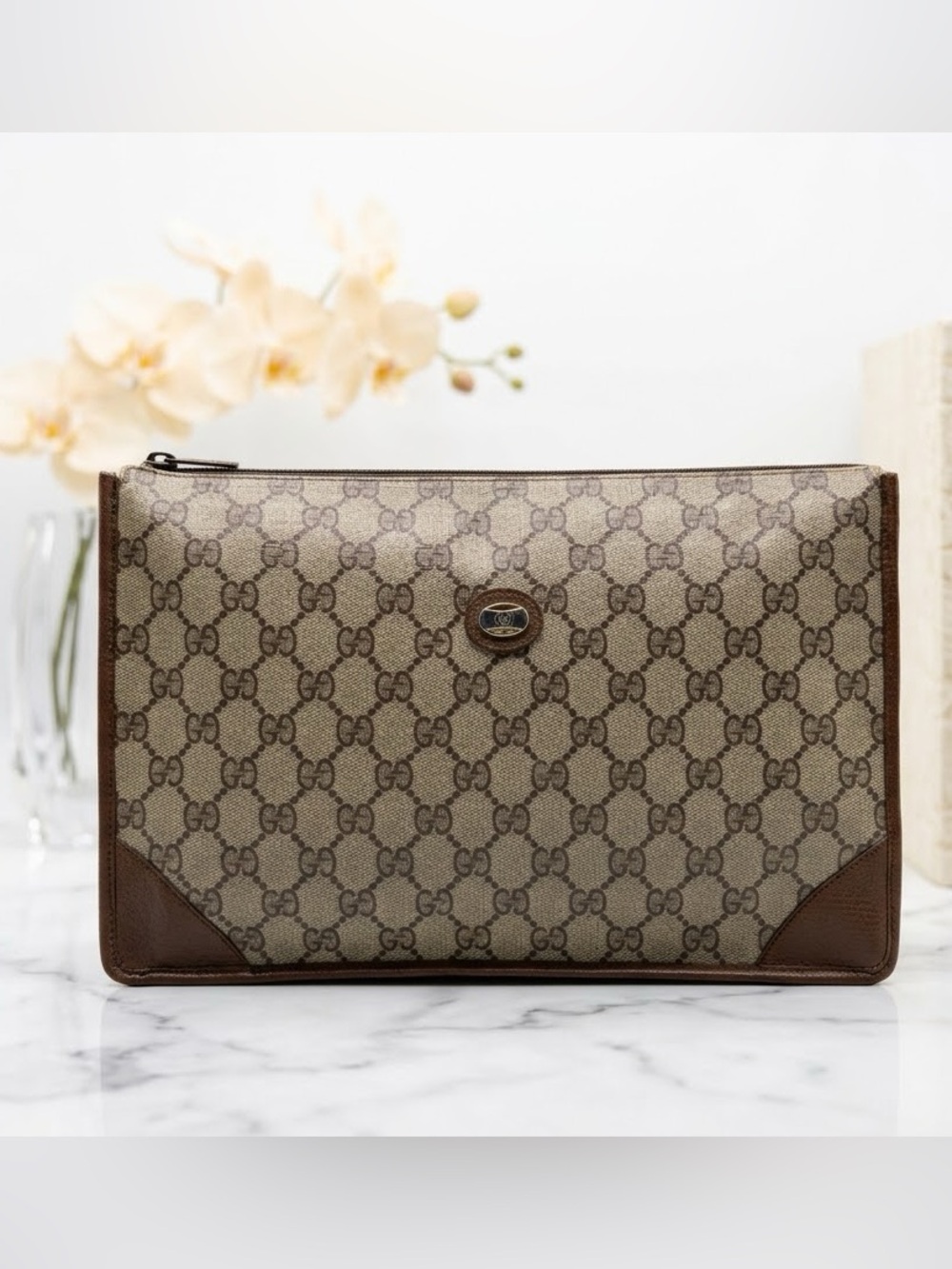 Gucci GG Vintage Supreme canvas clutch bag with leather trim.
